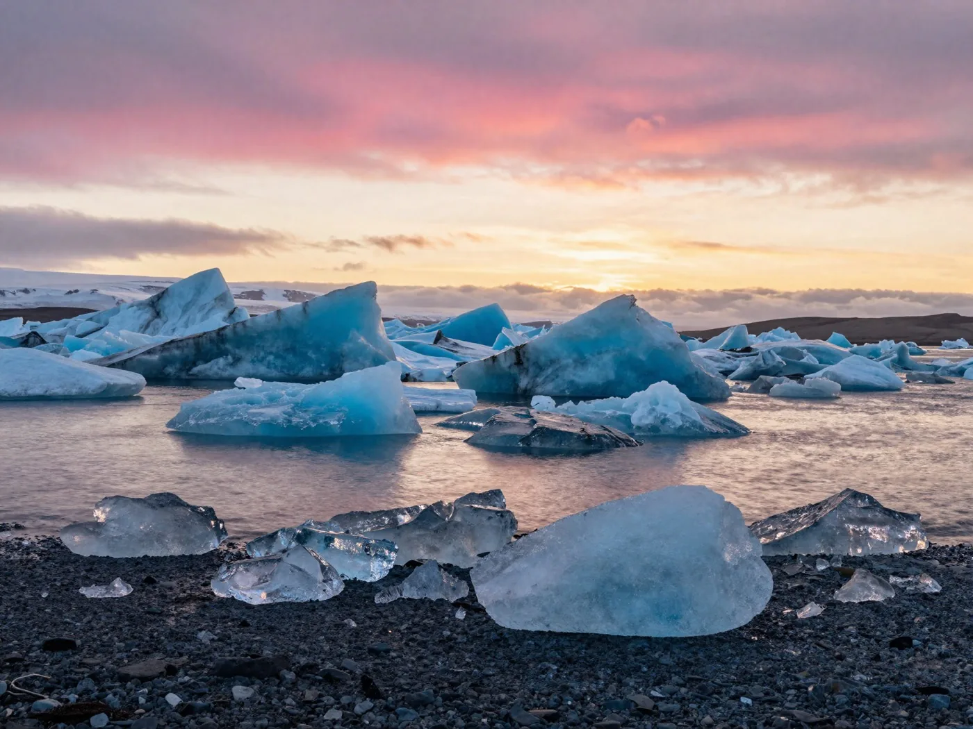 Icebergs floating in Jokulsarlon glacier lagoon at sunset